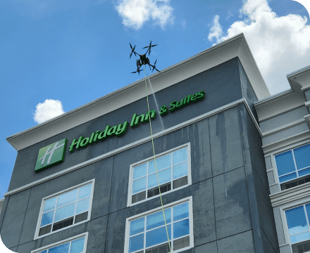 A drone cleaning the windows of a Holiday Inn.