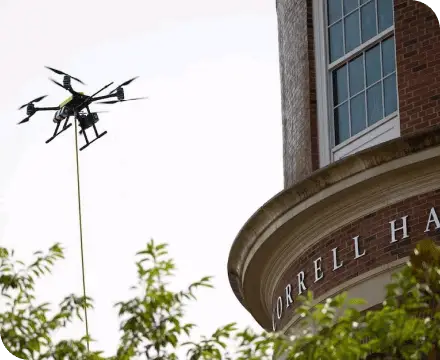 A drone cleaning the outside of a residential building.